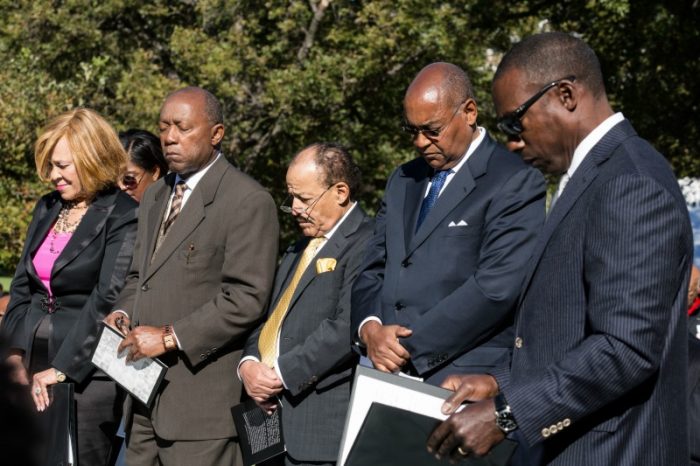  Members of the Texas Legislative Black Caucus, and the Texas African American History Memorial Foundation, bow their heads in prayer before the unveiling of the African American History Memorial outside the Texas State Capitol in Austin, Texas, on Saturday, Nov. 19, 2016. (Dave Creaney/Austin American-Statesman via AP)