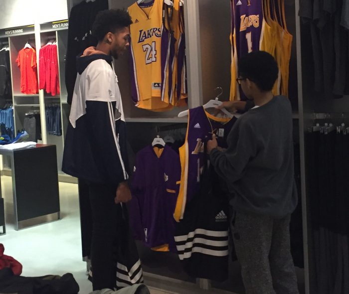 Ingram looks at Lakers jerseys with a shopping spree participant. (Courtesy of Excel Sports Management)