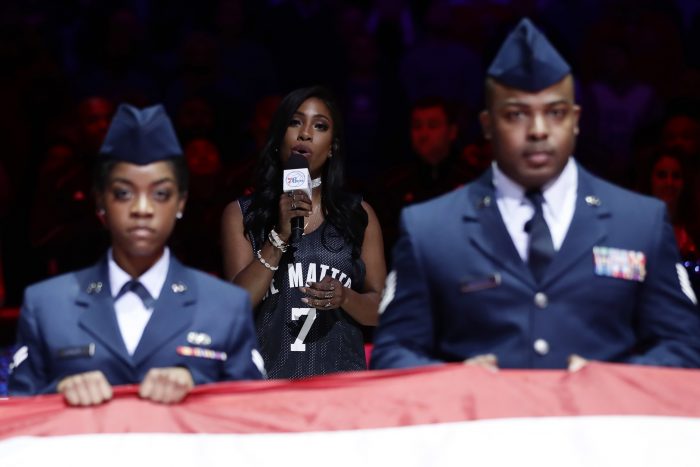 Sevyn Streeter, center, sings the national anthem before an NBA basketball game between the Philadelphia 76ers and the Los Angeles Lakers, Friday, Dec. 16, 2016, in Philadelphia. (AP Photo/Matt Slocum)