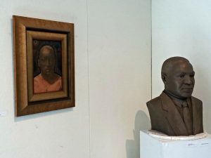 Sculpture of Patrick Jewett (left) and a painting by Eric Hall (right)