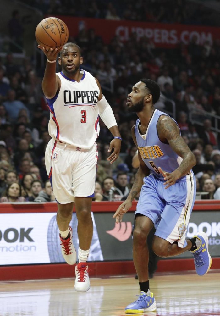 Los Angeles Clippers guard Chris Paul, left, shoots over Denver Nuggets guard Will Barton during the first half of an NBA basketball game in Los Angeles, Tuesday, Dec. 20, 2016. (AP Photo/Chris Carlson)