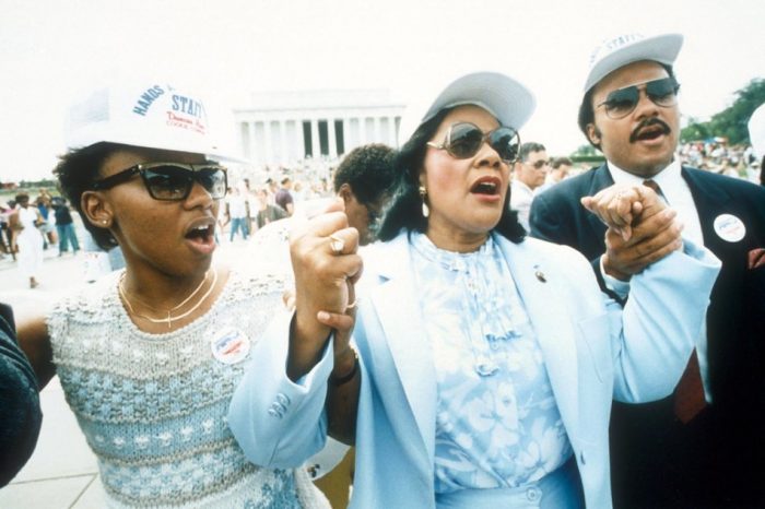 Coretta Scott King, center, holding hands with the her son, Martin Luther King III, right, and her daughter, Bernice, left, during the Hands Across America line near the Lincoln Memorial in Washington, D.C., Sunday, May 25, 1986. Millions of volunteers formed a human chain during a fund-raiser for the homeless and hungry.  (AP PHOTO/REED TOM) 