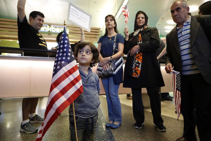 Three-year-old Shayan Ara holds an American flag as protests against President Donald Trump’s executive order banning travel from seven Muslim-majority countries continue at Los Angeles International Airport Sunday, Jan. 29, 2017. (AP Photo/Ryan Kang)