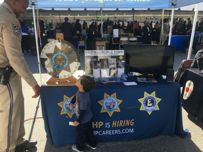  Officer Camrin Servio recruiting a future officer at the Hoops and Options College Fair. (courtesy photo) 