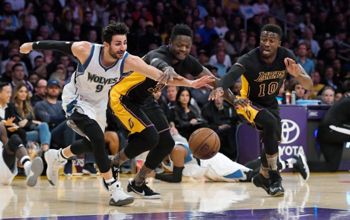 Minnesota Timberwolves guard Ricky Rubio, left, of Spain, scrambles for a loose ball along with Los Angeles Lakers forward Julius Randle, center, and guard David Nwaba during the first half of an NBA basketball game, Friday, March 24, 2017, in Los Angeles. (AP Photo/Mark J. Terrill)