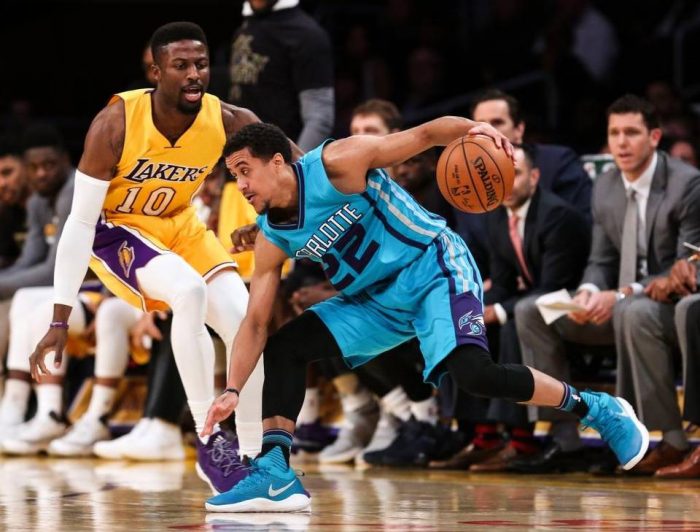 Los Angeles Lakers forward and former Cal Poly star David Nwaba defends Charlotte Hornets guard Brian Roberts, right, during the second half of an NBA basketball game Tuesday in Los Angeles. Ringo H.W. Chiu AP 