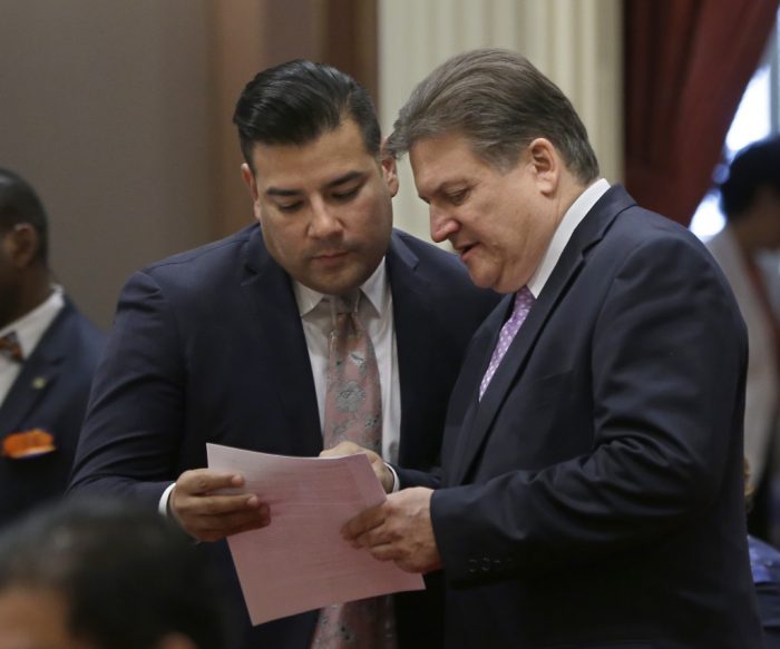 In this file photo, Sen. Robert Hertzberg, D-Van Nuys, right, discuss a bill with Sen. Ricardo Lara, D-Bell Gardens, at the Capitol, Thursday, Sept. 10, 2015, in Sacramento, Calif. Lara wrote a bill, later signed into law, that created a 14-member commission to redraw the boundaries for county supervisors' districts following the 2020 census. Los Angeles County has sued, saying the law harms 1 million voters.( Rich Pedroncelli/AP )